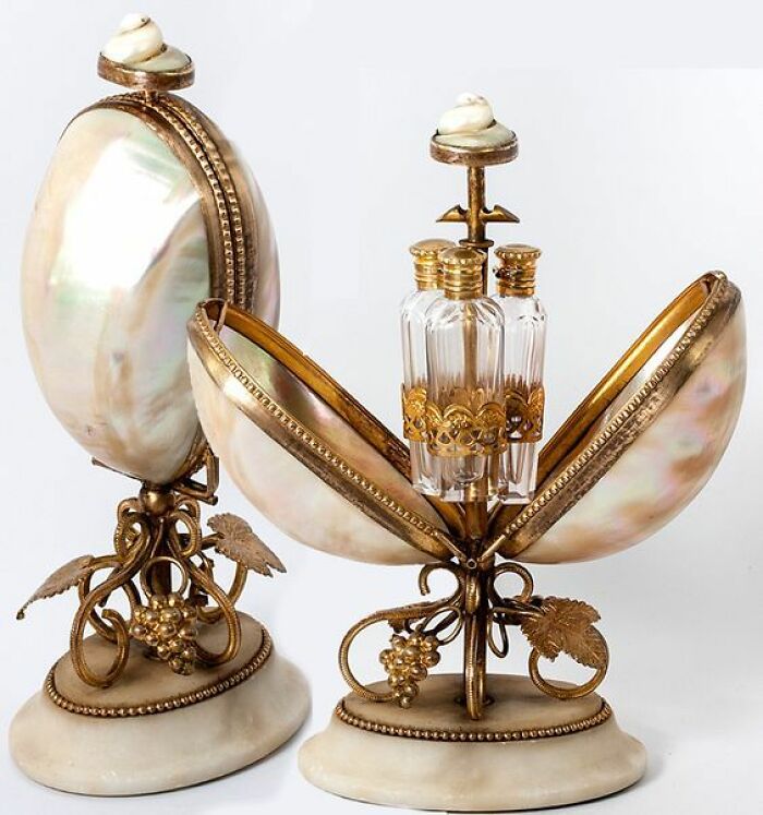 An exquisite perfume set, an intact object from many years ago, housed within an opened mother-of-pearl shell.