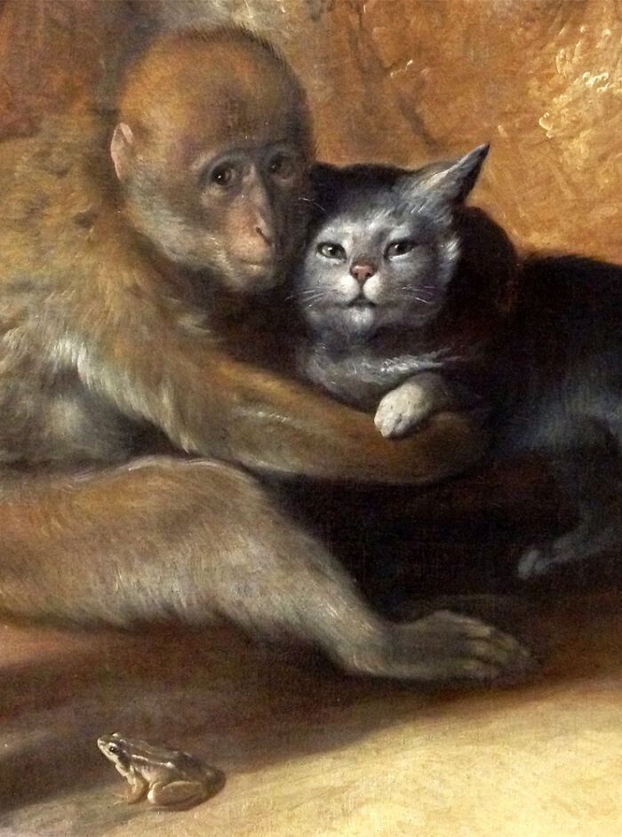 An old painting of a monkey embracing a cat, showcasing interesting intact photos and objects.