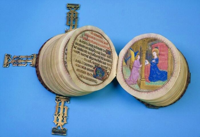An opened medieval prayer book with illustrations, a perfectly intact object from the past.