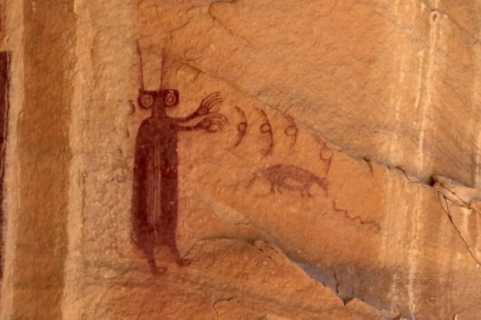 Ancient cave painting showing a human-like figure and animal, one of many intact objects.