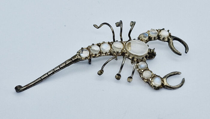 Scorpion-shaped brooch with moonstones, still intact after many years.