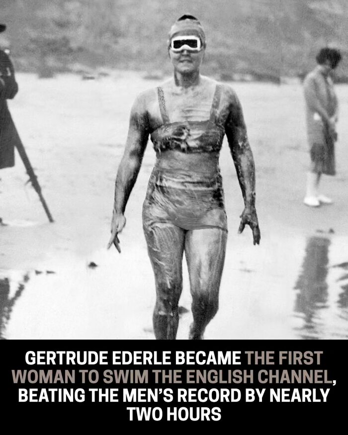 Historical photo of Gertrude Ederle, the first woman to swim the English Channel, walking out of the water.