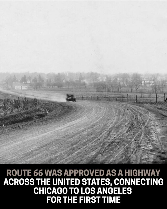 Black and white historical photo of Route 66, an early highway connecting Chicago to Los Angeles, with a car on the road.