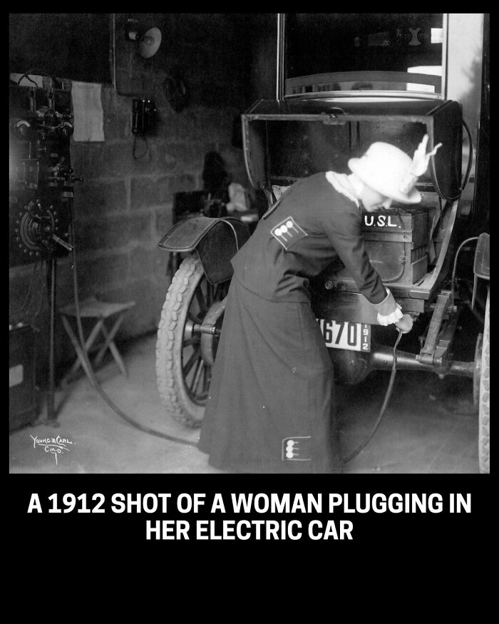 A rare historical photo from 1912 showing a woman plugging in her electric car.