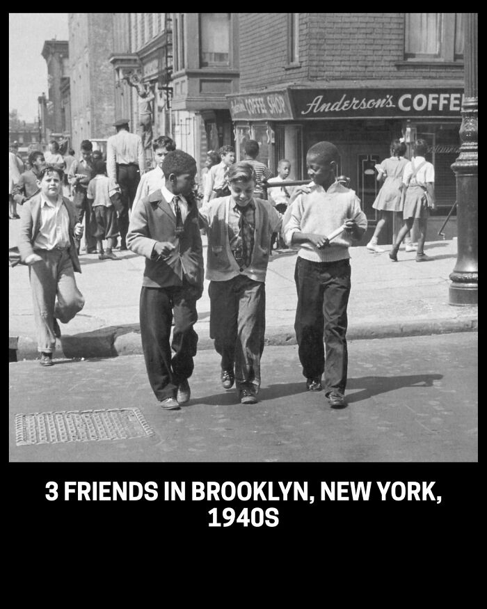 Three young friends walking down a street in Brooklyn, New York, in this historical photo from the 1940s.