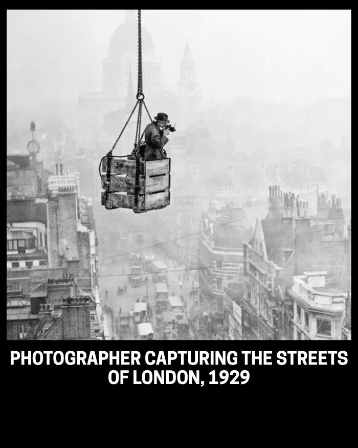 A photographer in a suspended basket capturing historical photos of London streets in 1929.