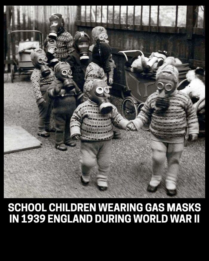 Children wearing gas masks in England during World War II, a rare historical photo.