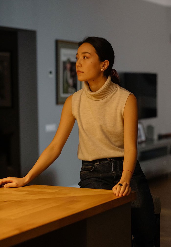 A woman at a table, looking concerned, realizing something was seriously wrong.