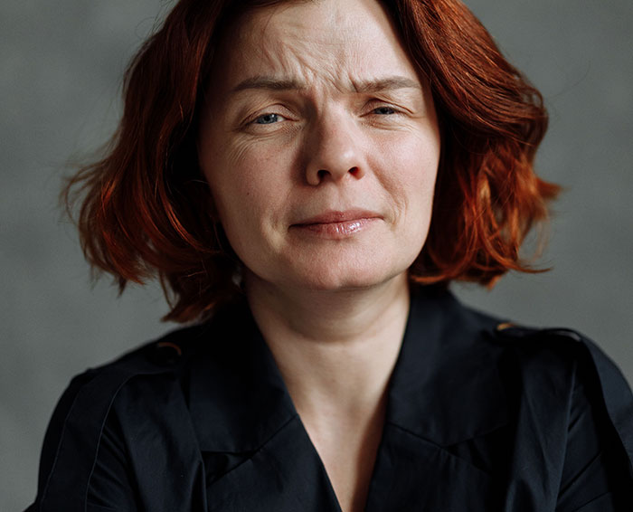 A woman with short red hair and a concerned expression, symbolizing a true crime fan's realization of something seriously wrong.