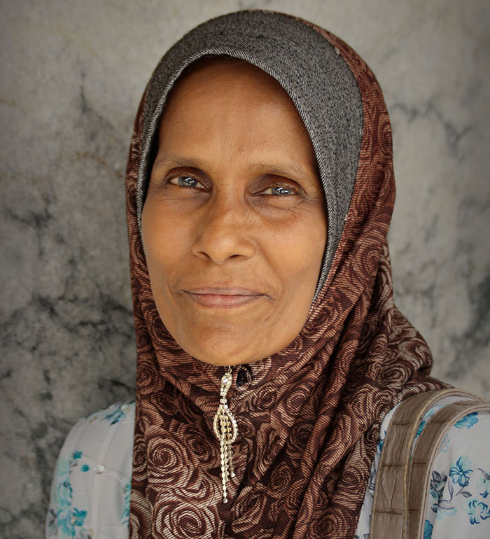 An older true crime fan in a headscarf, looking wise, having realized something was seriously wrong.