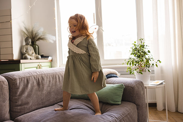 Child jumping on sofa illustrating child's health issues and behavior Child jumping on sofa illustrating child's health issues and behavior