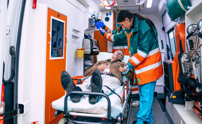 Man on a stretcher in an ambulance with paramedics, after fainting at a concert and wanting to go home. Man on a stretcher in an ambulance with paramedics, after fainting at a concert and wanting to go home.