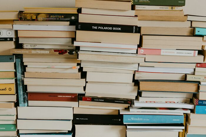 A tall stack of books, suggesting the many unusual jobs people somehow managed to get hired for.