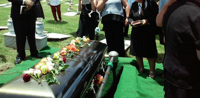 Funeral service with a casket decorated with flowers at a mass walkouts event