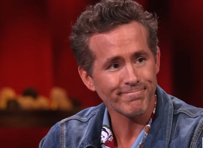 Deadpool star Ryan Reynolds, looking thoughtful, on screen.