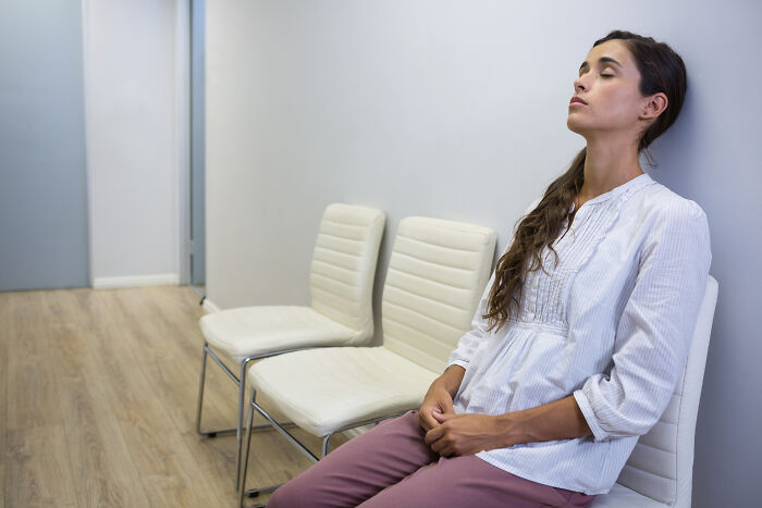 Woman patiently waiting on chair showing generosity and kindness
