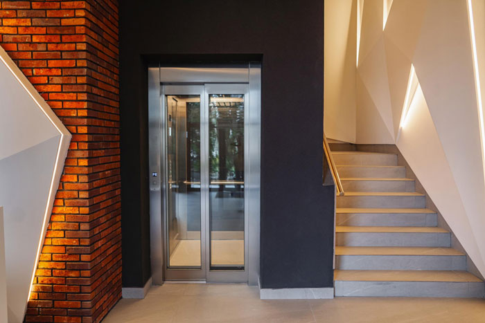 Modern school interior with an elevator and stairs, highlighting the challenge for a disabled teen without an elevator key.
