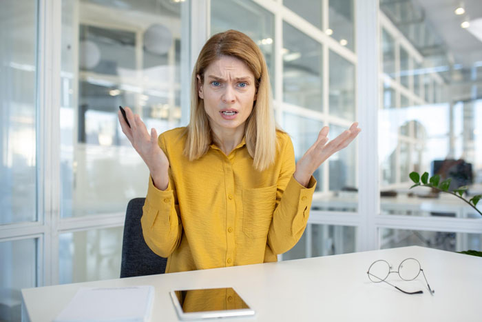 A frustrated woman in a yellow shirt gestures, representing the disabled teen's mom ripping into staff.