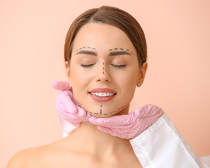 Woman with facial markings for cosmetic procedure on face Woman with facial markings for cosmetic procedure on face