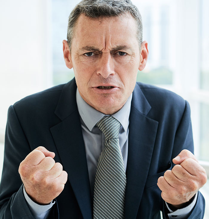 An angry man clenching his fists, illustrating the frustration when secrets ruin lives.