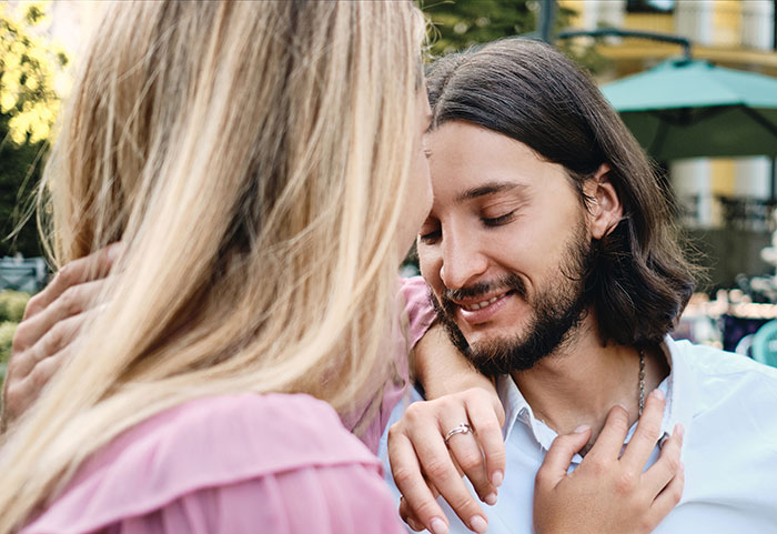 A man and a woman embracing, sharing a moment of intimacy and showing the secrets people keep to themselves.