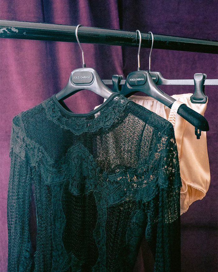 A black sheer lace top hanging, representing a sheer look similar to Shania Twain's.
