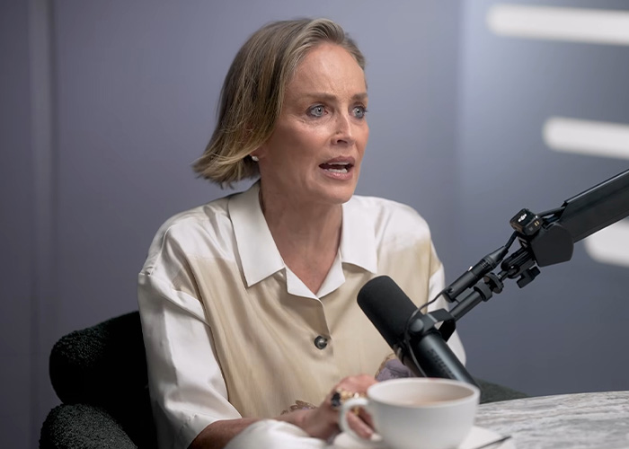 Sharon Stone speaking into microphone in podcast about her surgery