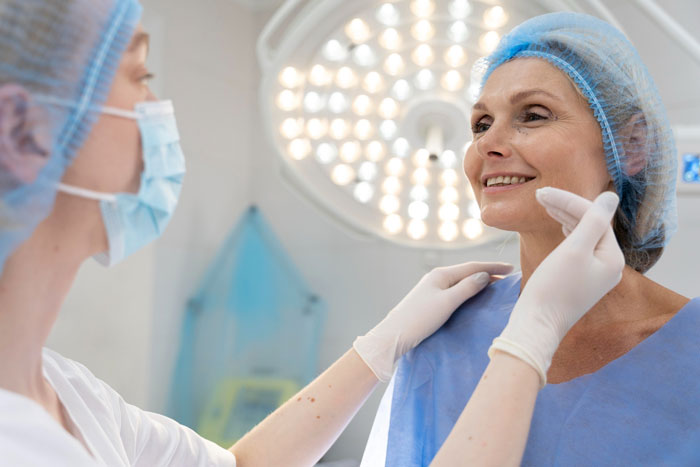Smiling older woman with nurse before cosmetic plastic surgery fillers and Botox Smiling older woman with nurse before cosmetic plastic surgery fillers and Botox