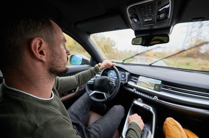 Man driving car inside vehicle showing smooth criminals lifestyle