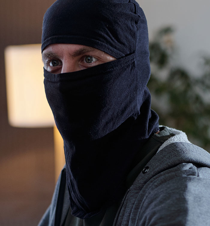 Man wearing black balaclava mask with serious expression