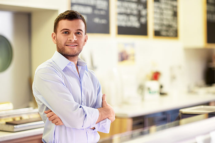 Confident man standing in cafe representing smooth criminals concept