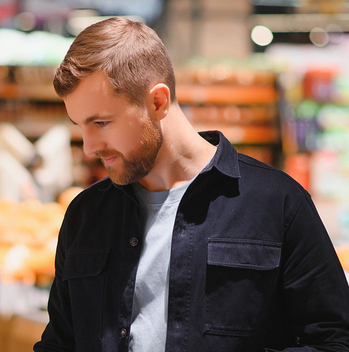 Young man shopping in store symbolizing everyday smooth criminals
