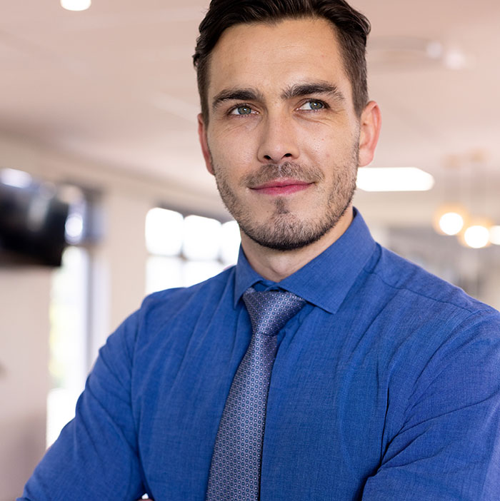 Confident man in blue shirt and tie representing smooth criminals