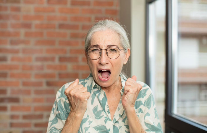 Angry older woman expressing frustration at home Angry older woman expressing frustration at home