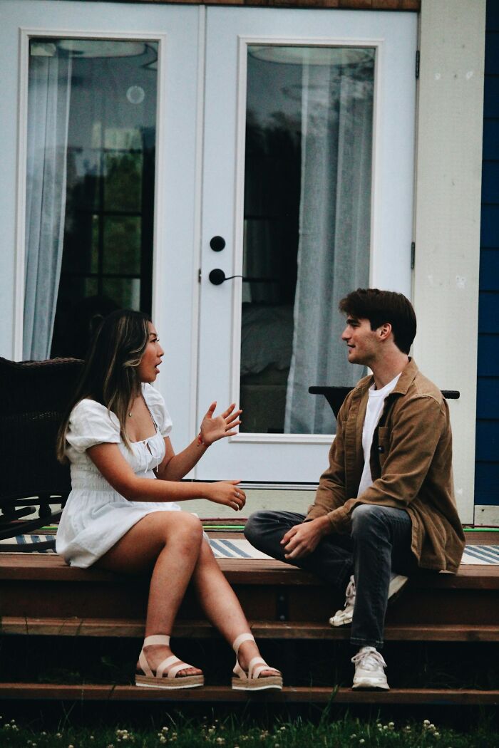 Two people engaged in conversation, a hint that a person is secretly very smart by being a good listener.