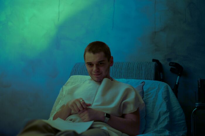 Patient in hospital bed under mysterious green light