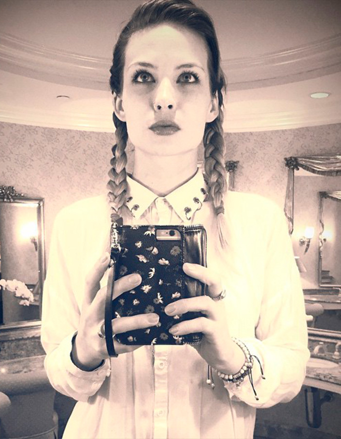 Daveigh Chase, star of The Ring and Lilo & Stitch, taking a mirror selfie, looking up, holding a phone.