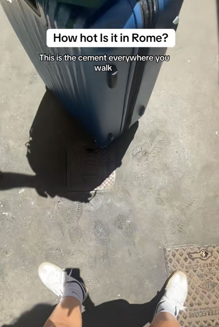 A person's feet and a suitcase casting a dark shadow on the melting cement in Rome due to the heatwave.