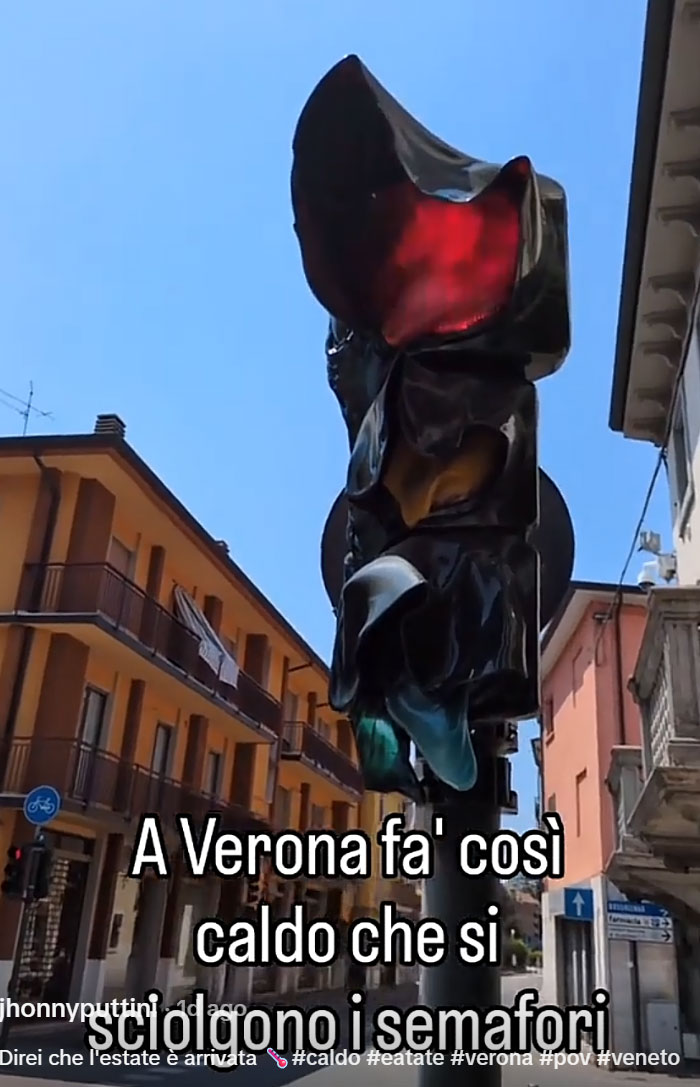 A melting traffic light in Verona, Italy, showing the extreme heatwave conditions.