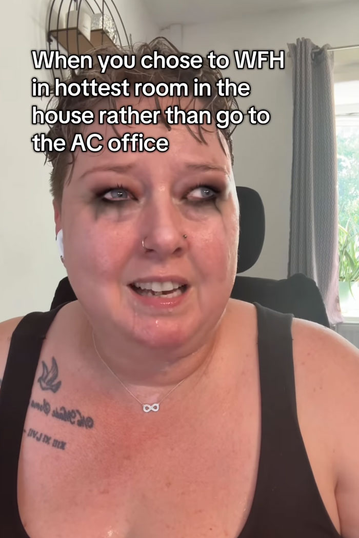 A woman sweating with makeup running down her face, trying to survive the heatwave.
