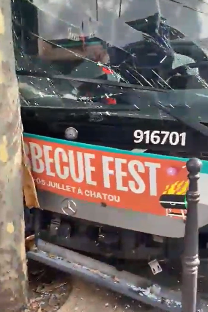A bus with a shattered windshield in Europe, likely damaged during the heatwave.