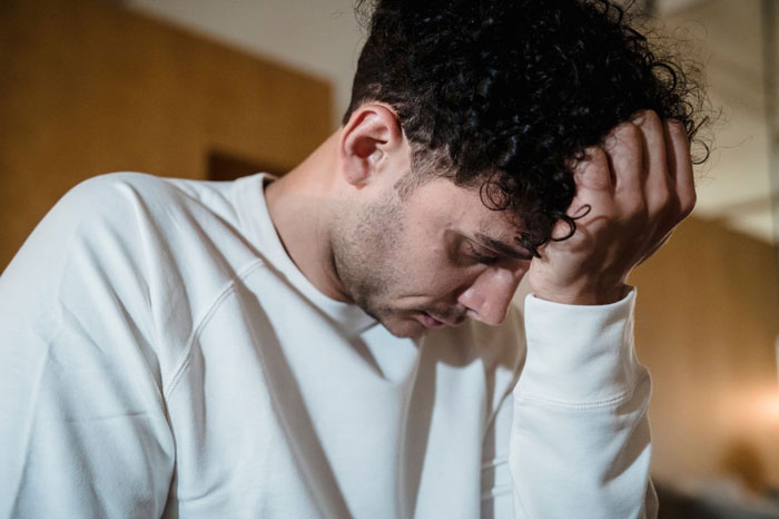 Man in distress experiencing panic attack at home Man in distress experiencing panic attack at home