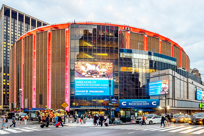 Exterior of Madison Square Garden during the day, surrounded by city traffic, related to Taylor Swift's wedding backlash.