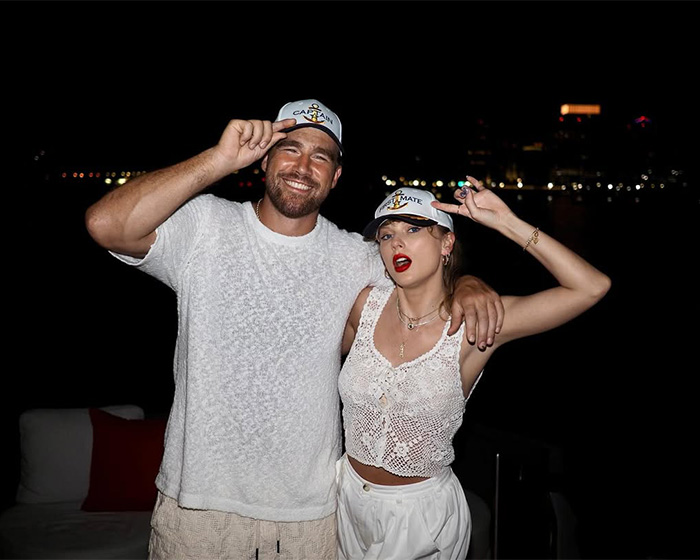 Taylor Swift and Travis Kelce wearing matching hats, sparking wedding rumors and backlash.