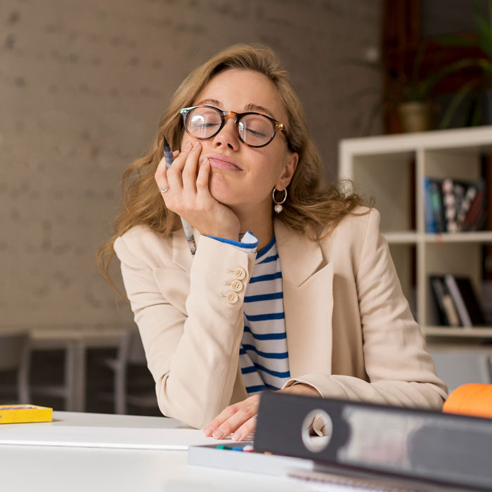 Tired teacher looking frustrated during grading session