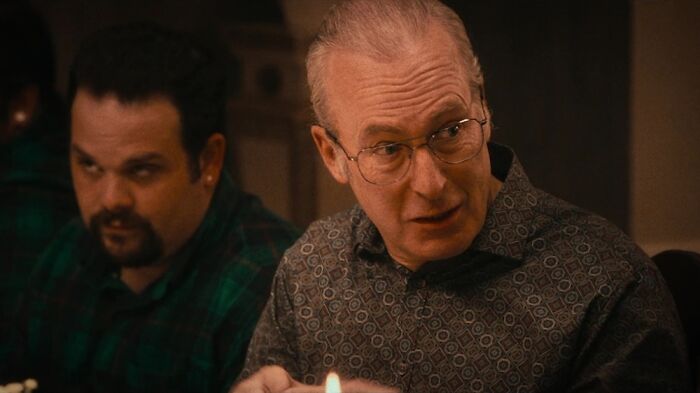 A close-up of guest star John Mulaney in a scene from The Bear Season 5, with another actor in the background.