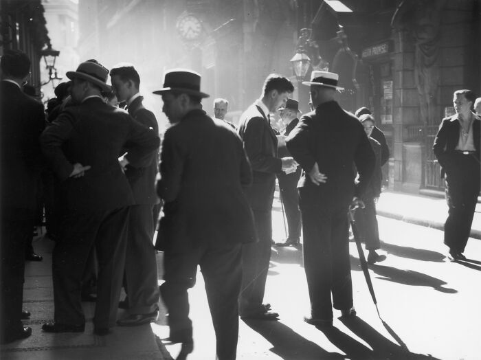 Black and white image of men gathered on street representing AI-caused great depression impact
