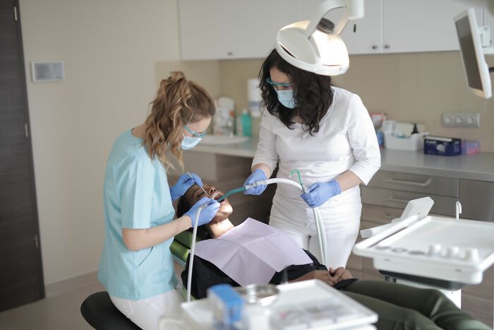 Dentists treating patient representing healthcare in AI-caused great depression