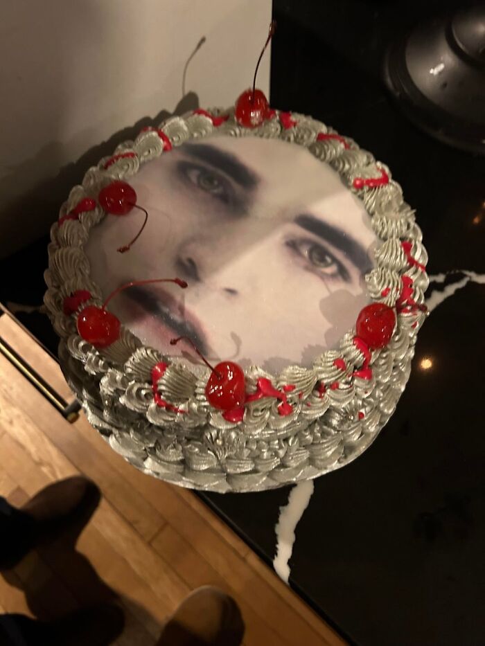 Cake with a realistic human face and cherries on top