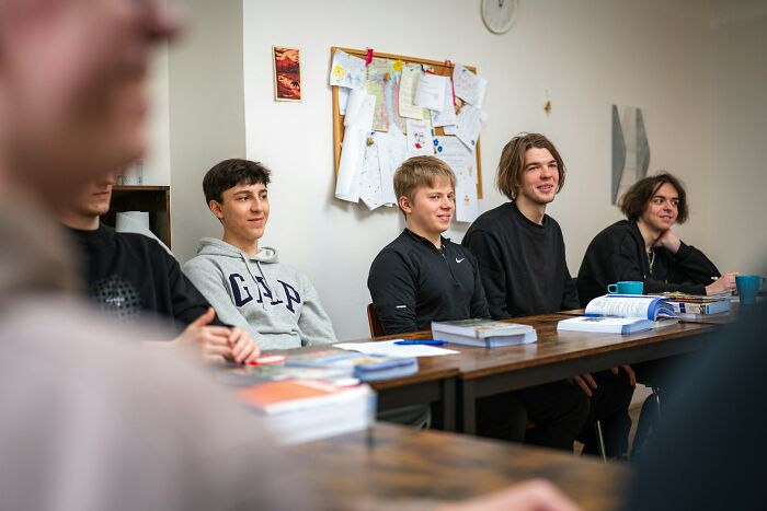Group of teenage students engaged in a classroom discussion on literacy